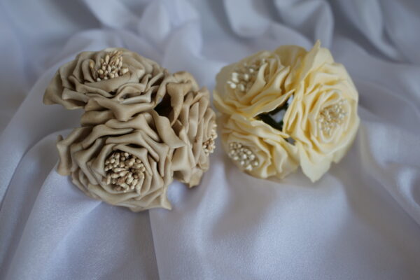 Image of artificial foam roses, one in a mocha colour and the other in cream