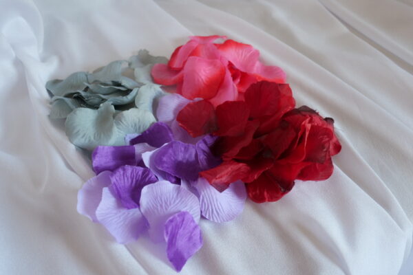 Image of artificial petals, in grey, purple, pink and dark red