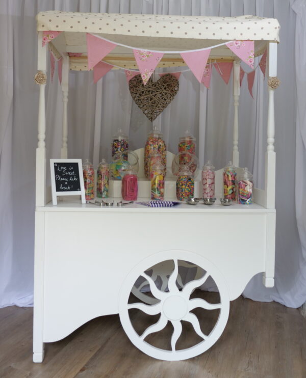 Image showing white wooden sweet cart with sweet jars