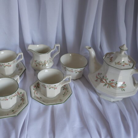 Image of teapot, 4 cups and saucers, a sugar bowl and a milk jug.