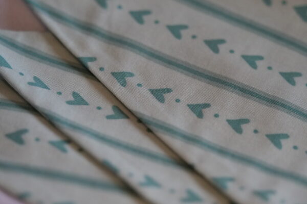 Blue striped material triangle bunting with a love heart pattern