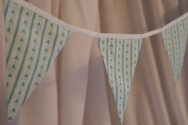 Blue striped material triangle bunting with a love heart pattern