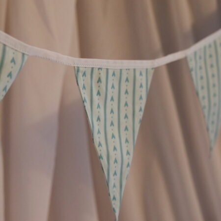 Blue striped material triangle bunting with a love heart pattern