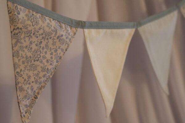 Alternating grey, cream and wildflower pattern triangle bunting
