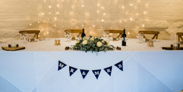 Mr & Mrs lettering on blue bunting draped on a table